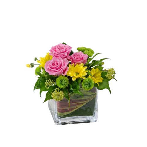 Joy - pink, green and yellow flowers arranged in a clear vase