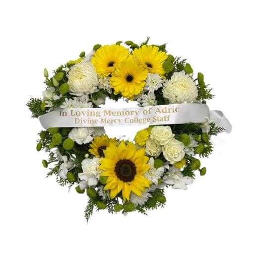 white and yellow wreath with ribbon
