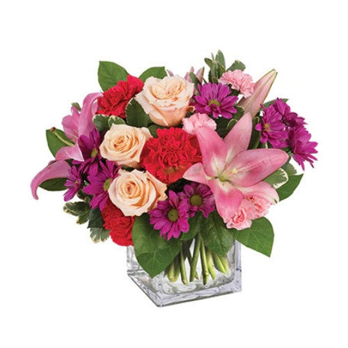 Barbiecore Floral Arrangement - pink and purple flowers arranged in a clear cube