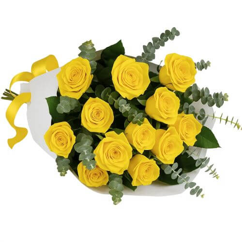 Bouquet of yellow roses with greenery in a white container on a white background